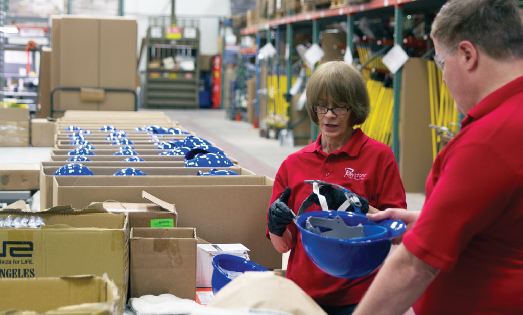 Photo of keystone employees assembling helmets.