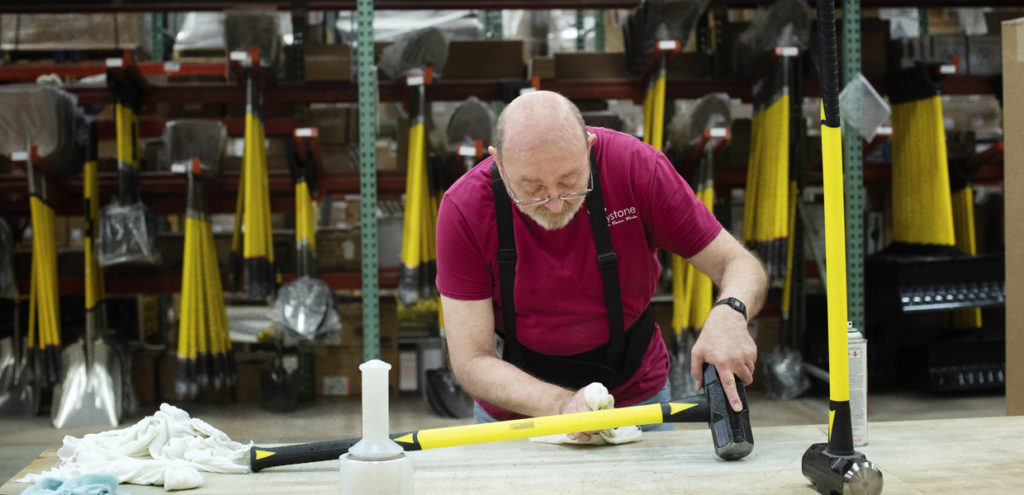 Keystone employee cleans sledge hammers before shipping.